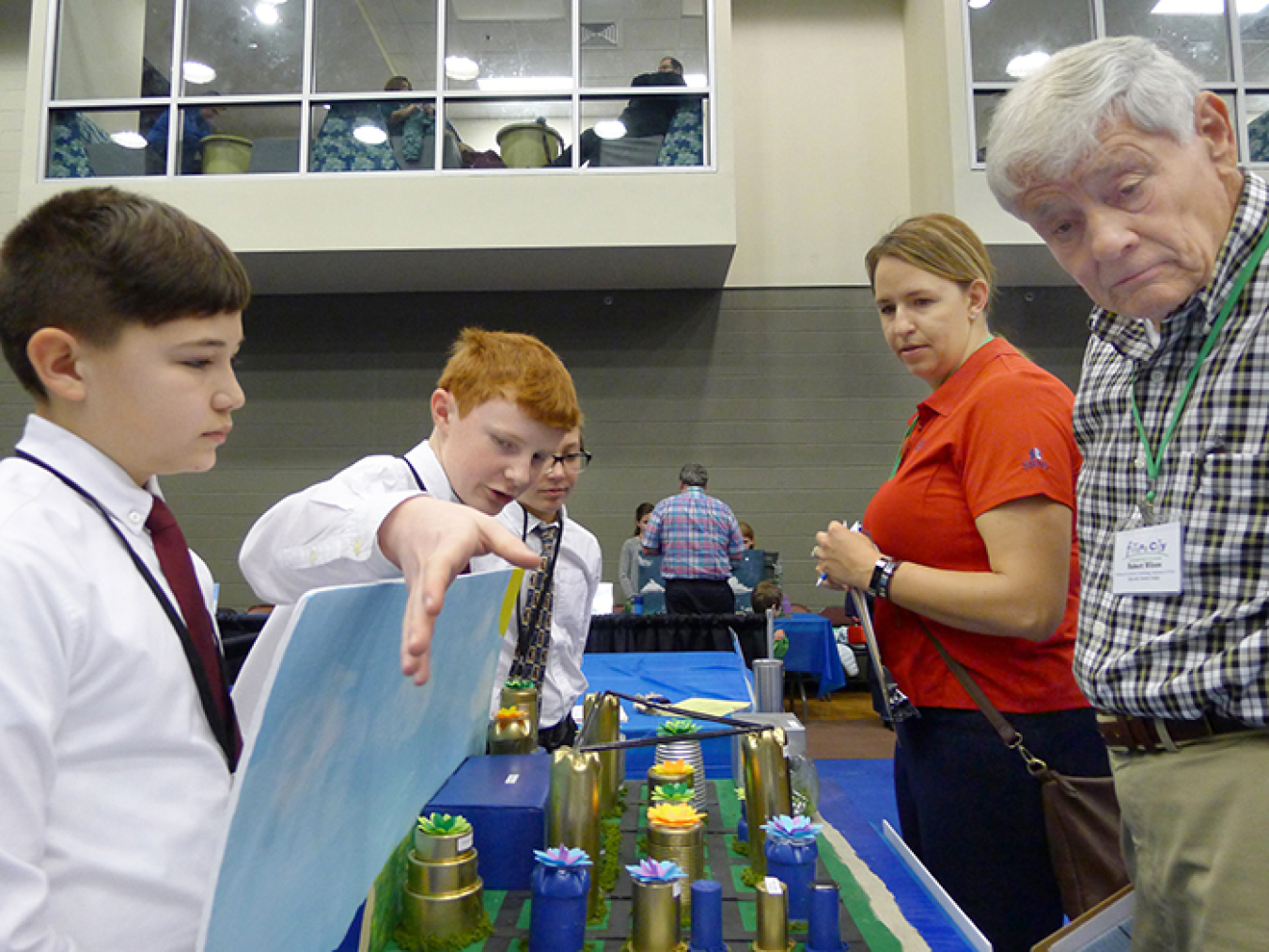 From left, Seventh-graders Cody Goldschmidt, Aaron Arnold, and Alex Trippi from Kennedy Middle School in Aiken, South Carolina guide judges Marissa Reigel and Robert Wilson from the organization Citizens for Nuclear Technology Awareness through their mode