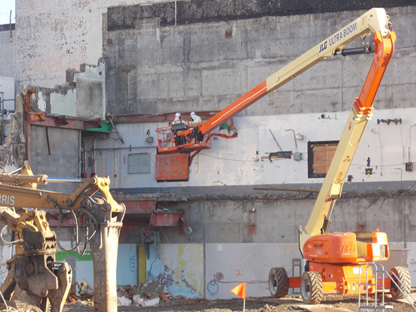 Radiation technicians from area small business InTomes survey of the exposed exterior wall of the Main Plant Process Building at EM’s West Valley Demonstration Project Site after the demolition of the Main Plant Office Building.