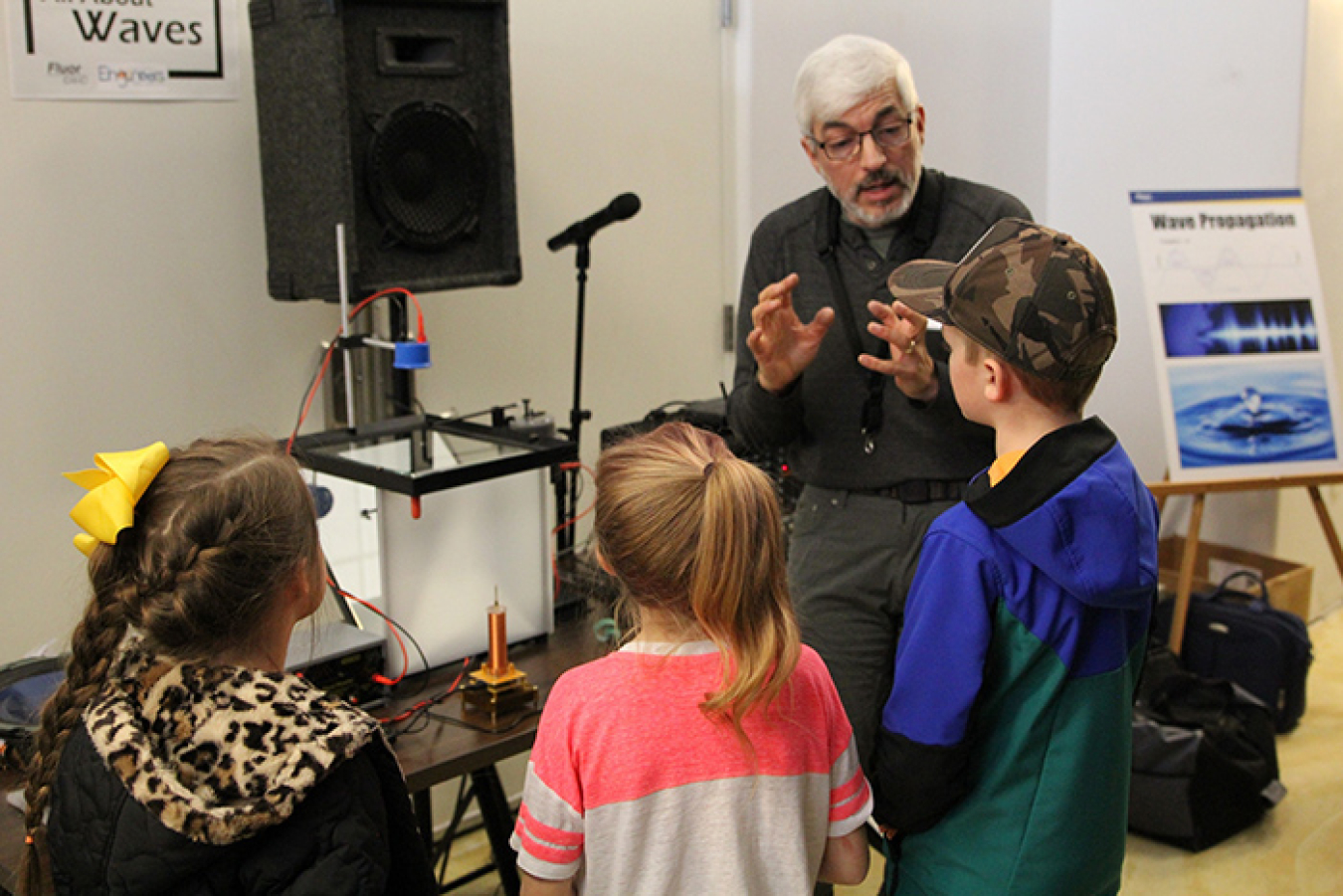 Kevin Young, who works for Fluor Idaho partner North Wind Portage, teaches students about how waves form during Engineering Day at the Museum of Idaho.