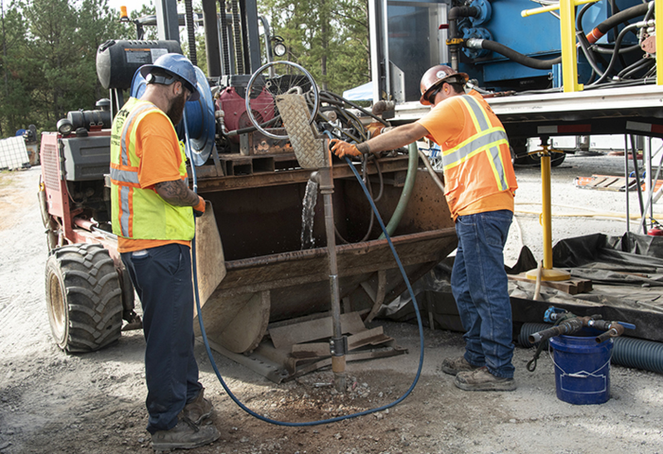 Injecting material containing iron filings into wells at the Savannah River Site is a multi-step process. A well is flushed with water, shown here, before workers add the iron filings to it. 