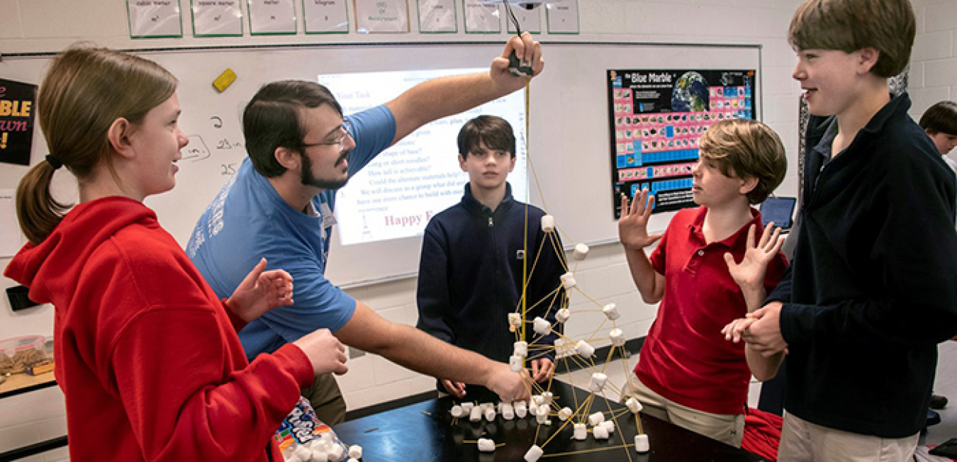 Savannah River Nuclear Solutions Engineer Graham Jones measures the height of a tower built using only marshmallows and uncooked noodles during a Savannah River Site teach-in at the Episcopal Day School in Augusta, Georgia.