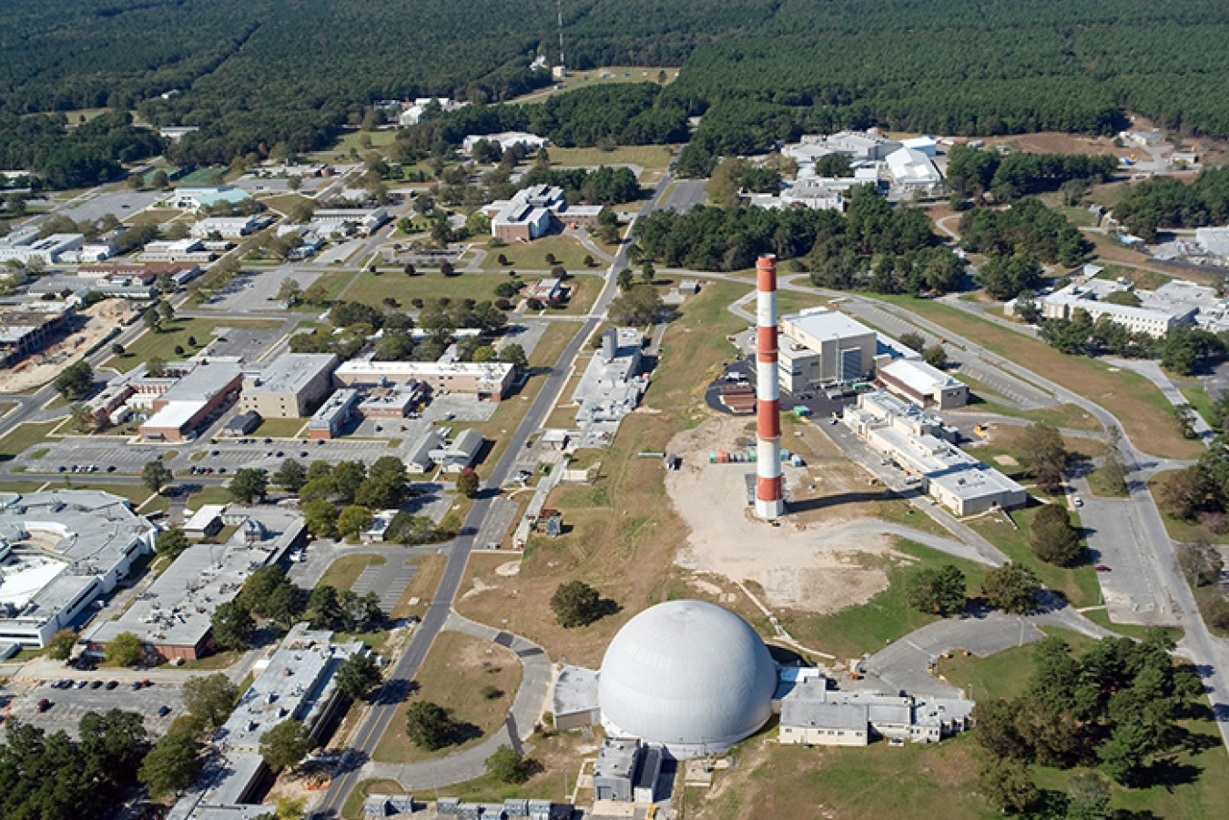 The red-and-white High Flux Beam Reactor exhaust stack — a pronounced part of the Brookhaven National Laboratory skyline for more than 70 years — is slated for demolition later this year.