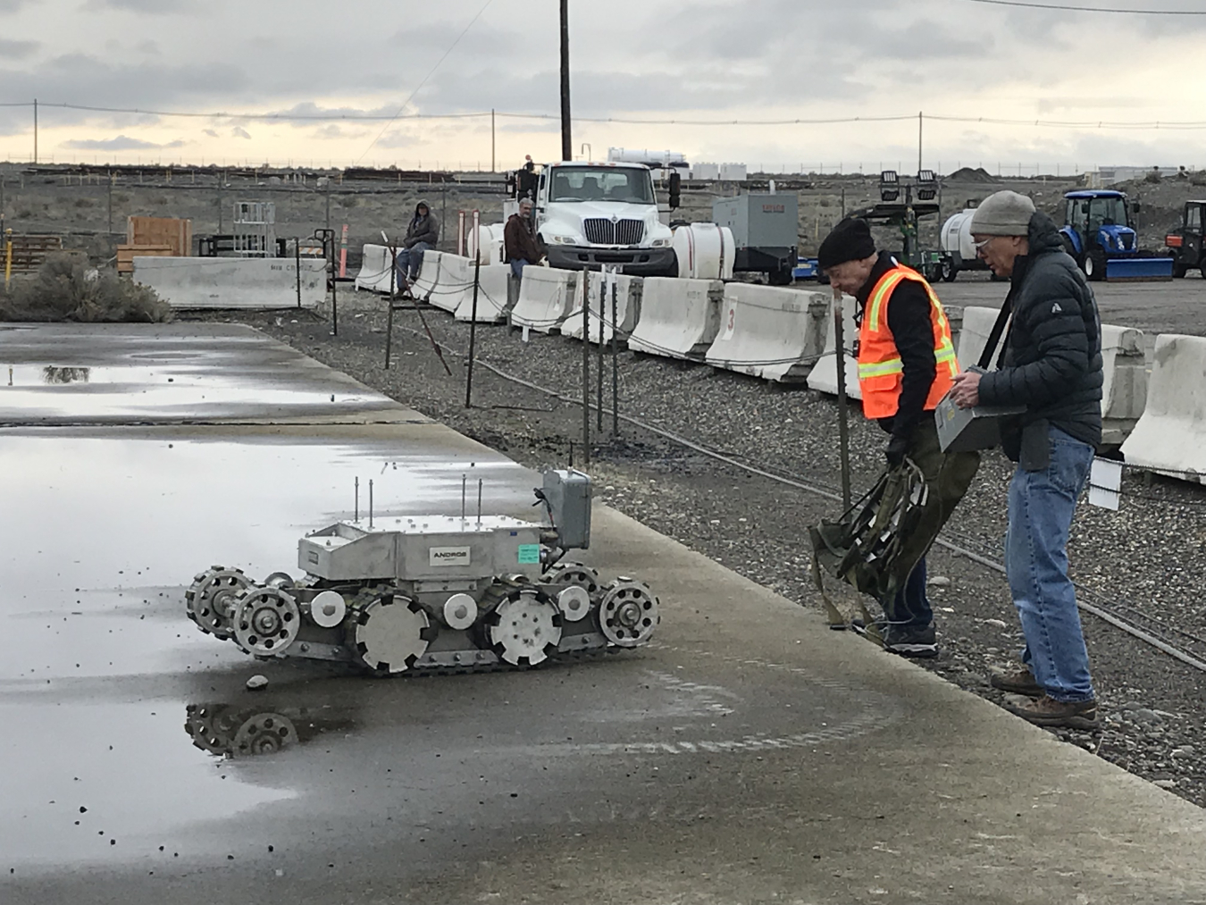 Workers with Hanford contractor CH2M HILL Plateau Remediation Company test a robotic crawler on the roof of a former fuel storage bunker. The crawler was used to safely evaluate the load capacity of the roof as part of preparations for future demolition a