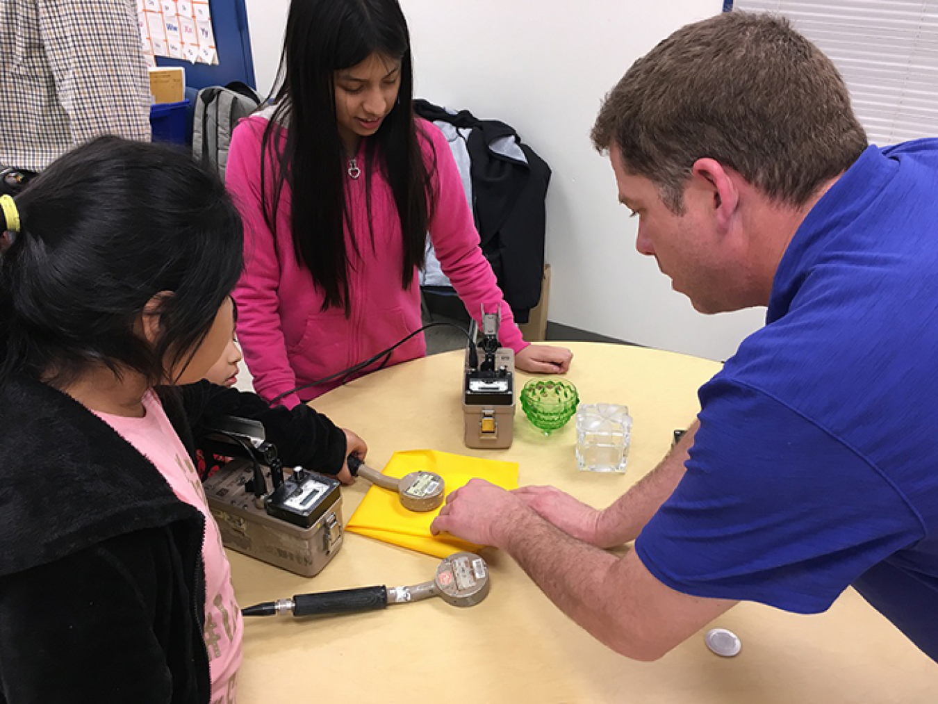 Mike Franklin, a field radiological engineer with UCOR, shows students how to use instrumentation to survey and detect radiation at the STEM event at Jefferson Middle School in Oak Ridge.