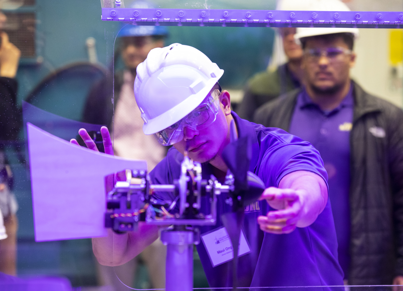 A student installs his team’s turbine in a wind tunnel for a test during the CWC 2019 Technical Challenge.