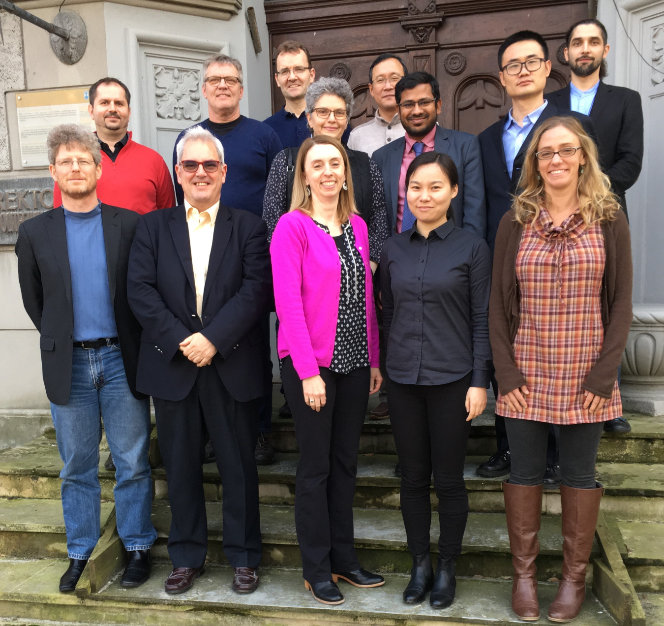 Photo of 13 adults posing and smiling.