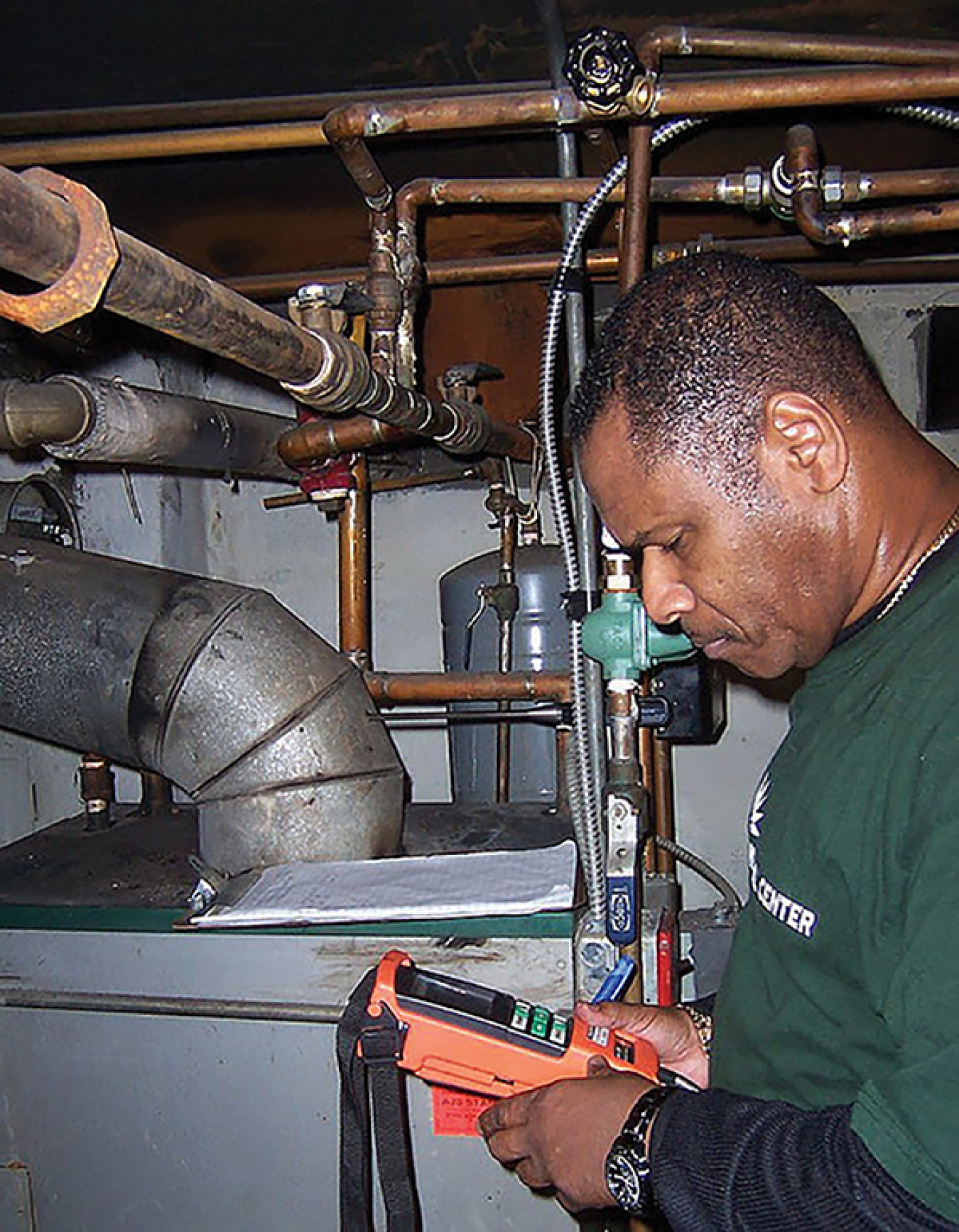 Weatherization worker performing a boiler test.