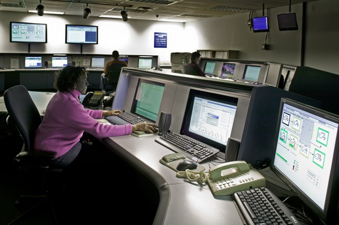 Janice Sandford, forefront, and other operators are shown in the Defense Waste Processing Facility control room. Savannah River Remediation recently upgraded its control system hardware and software.