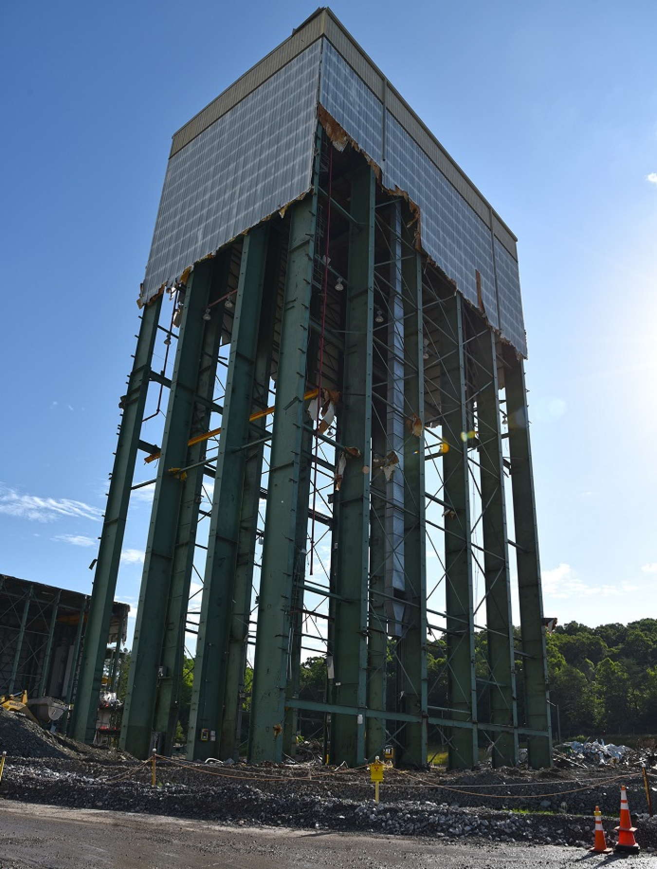 Workers used powerful winches to pull down the steel beams of the 180-foot tower of Building K-1220 at Oak Ridge. 