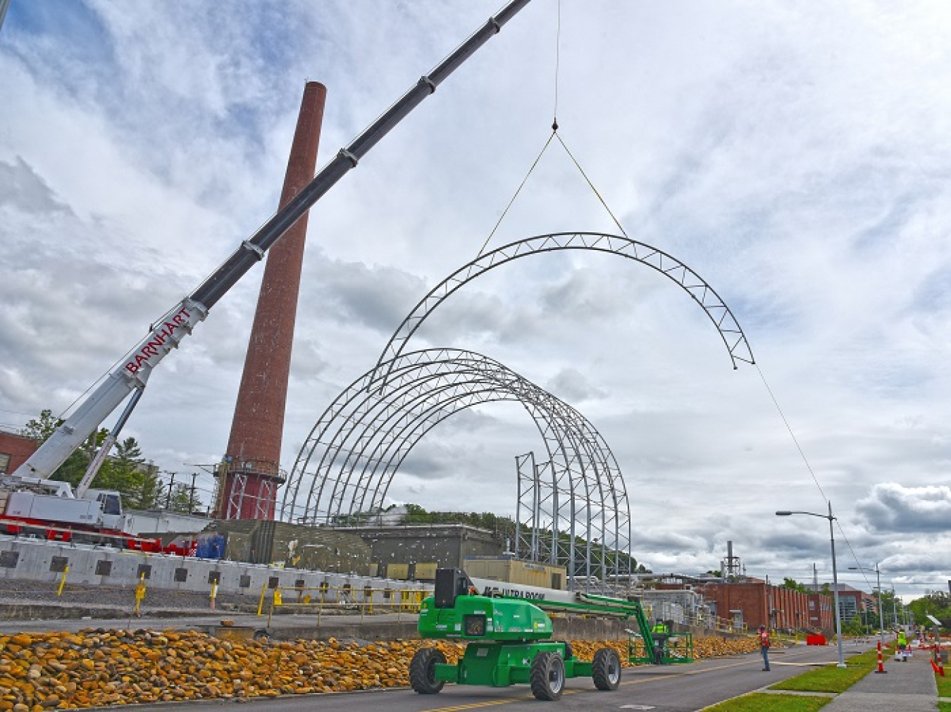 A 175-ton crane is being used to install a six-story protective cover to keep research facilities near Building 3026 safe during demolition. 