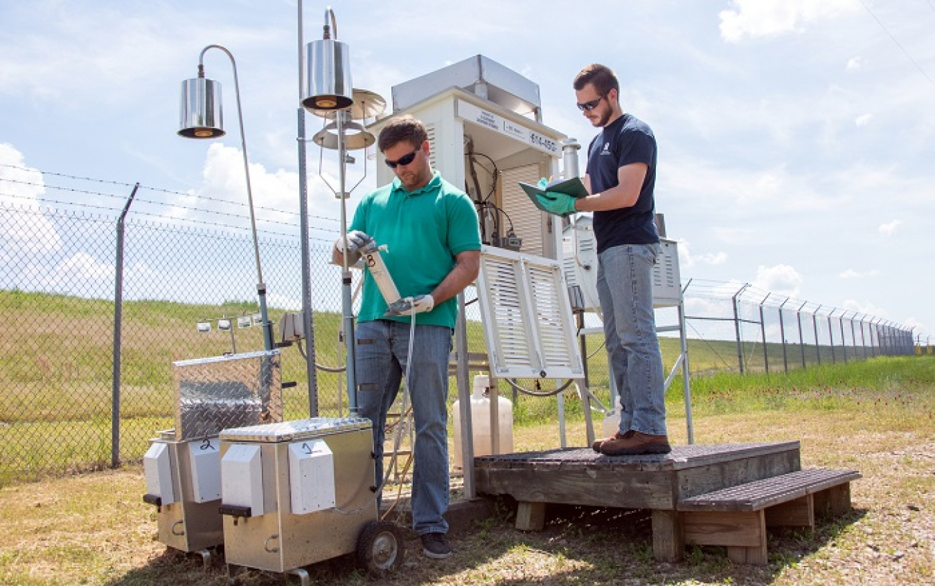 In this February 2020 photo, Savannah River Nuclear Solutions (SRNS) Scientist Jason Walker, left, inspects a new portable air monitoring station.