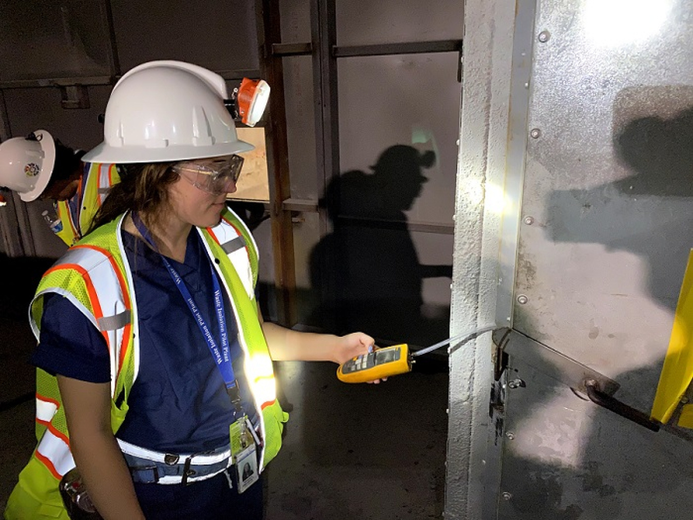Emerson Brazile, a Nuclear Waste Partnership (NWP) summer intern, measures pressure across the bulkhead in the Waste Isolation Pilot Plant (WIPP) underground.