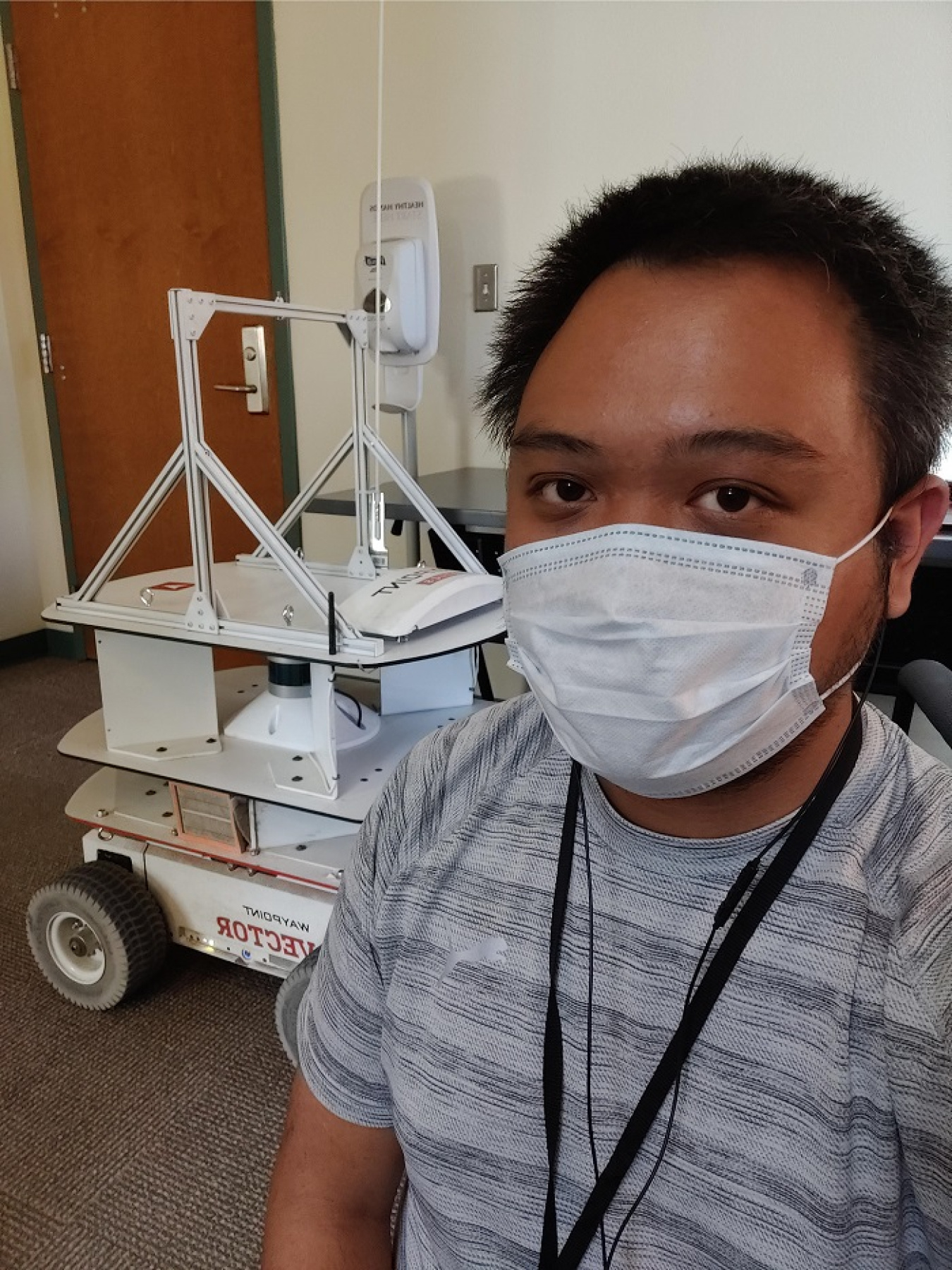 Pictured is Jeff Natividad and the Vector Waypoints robot. Natividad is working on a project to perfect an autonomous mobile robot for use in the Hanford tank farms.
