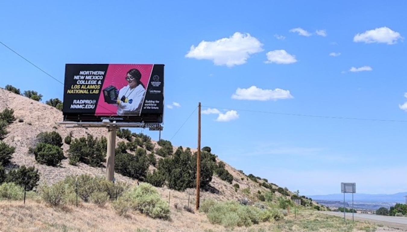 A billboard in Pojoaque along Highway 502 promotes the collaborative program between Northern New Mexico College and the Laboratory.