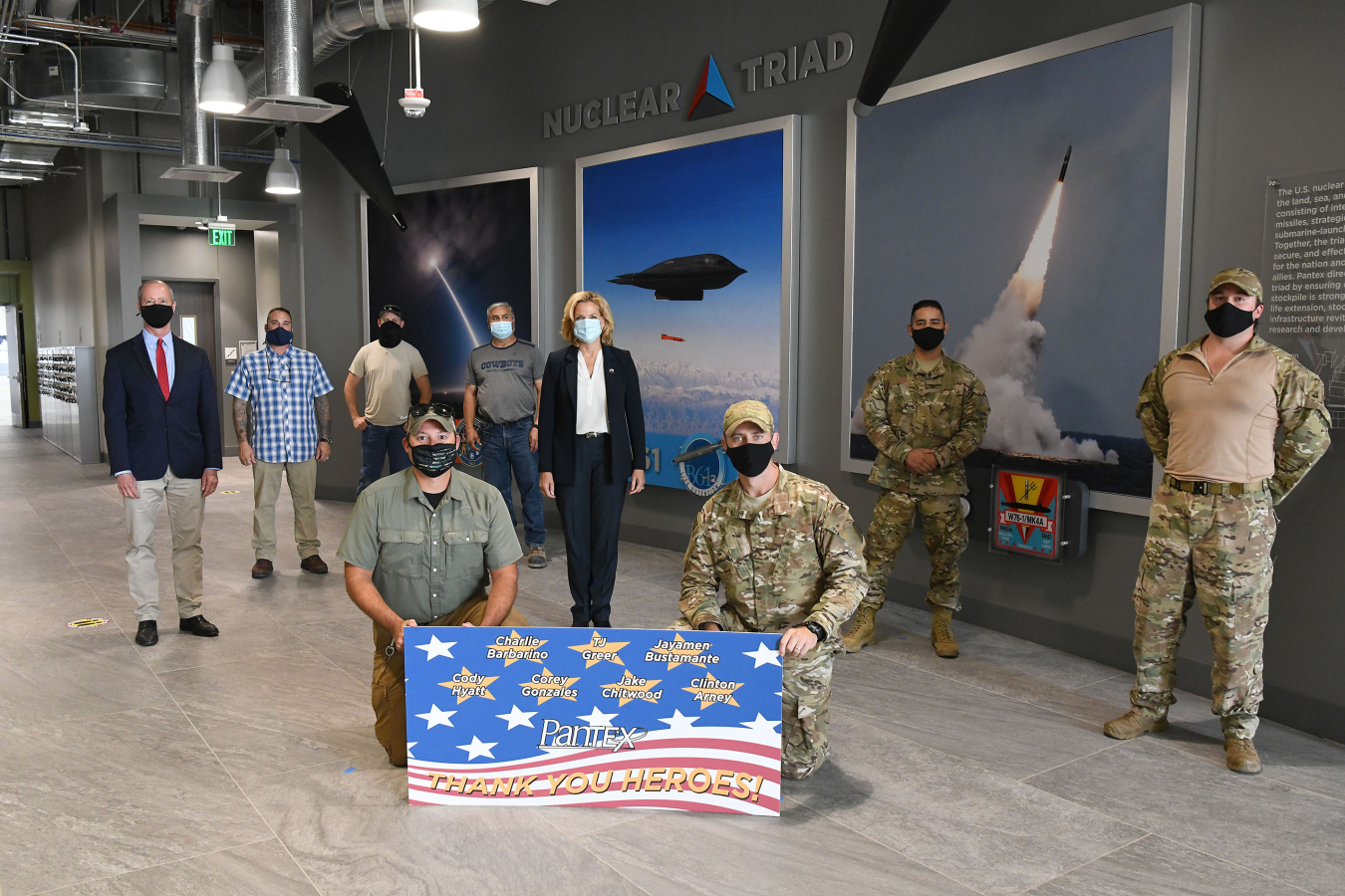 NNSA Administrator Lisa E. Gordon-Hagerty and U.S. Rep. William “Mac” Thornberry , left, pose for a group picture with attendees of a Heroes Luncheon. The employees honored helped save lives while off-duty.