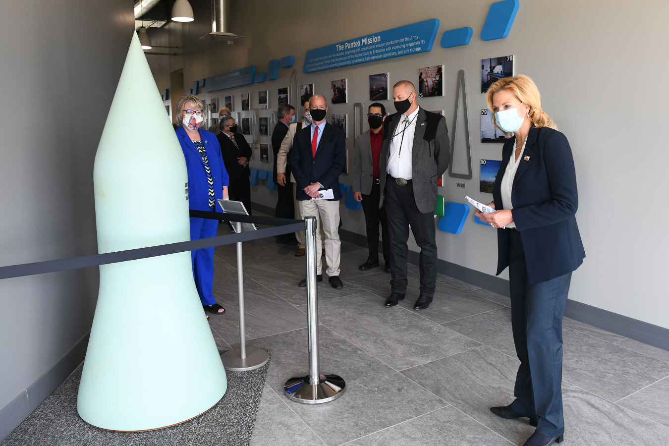 From left, Consolidated Nuclear Security President Michelle Reichert, U.S. Rep. William “Mac” Thornberry, Pantex graphic artist Deron Lucero, NNSA’s Geoff Beausoleil, and NNSA Administrator Lisa E. Gordon-Hagerty tour the new Pantex history display.