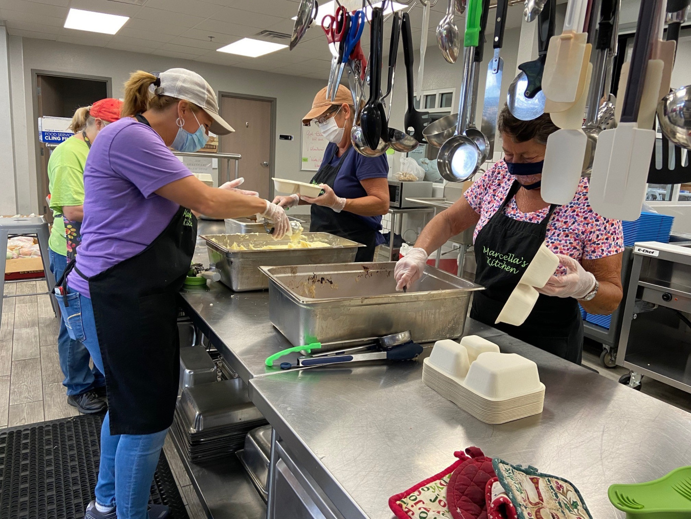 Marcella’s Kitchen volunteers prepare meals to be packaged and distributed to those in need in Marshall County. 