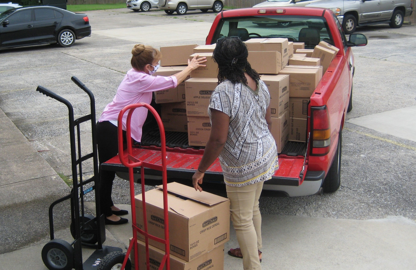 Paducah Cooperative Ministries Executive Director Heidi Suhrheinrich and emergency Services/Volunteer Coordinator Karen Burton unload a truckload of food purchased with recently donated funds from the Feds Feed Families campaign.