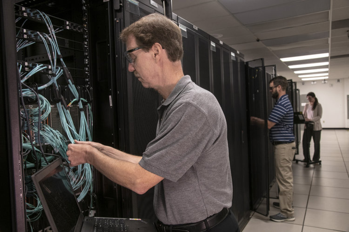 From left, Savannah River Nuclear Solutions IT Network Engineers Alan Chafin, Kyle Garner, and Nicole Arnold complete the configuration of 800 computer network switches in dozens of buildings across the Savannah River Site. 