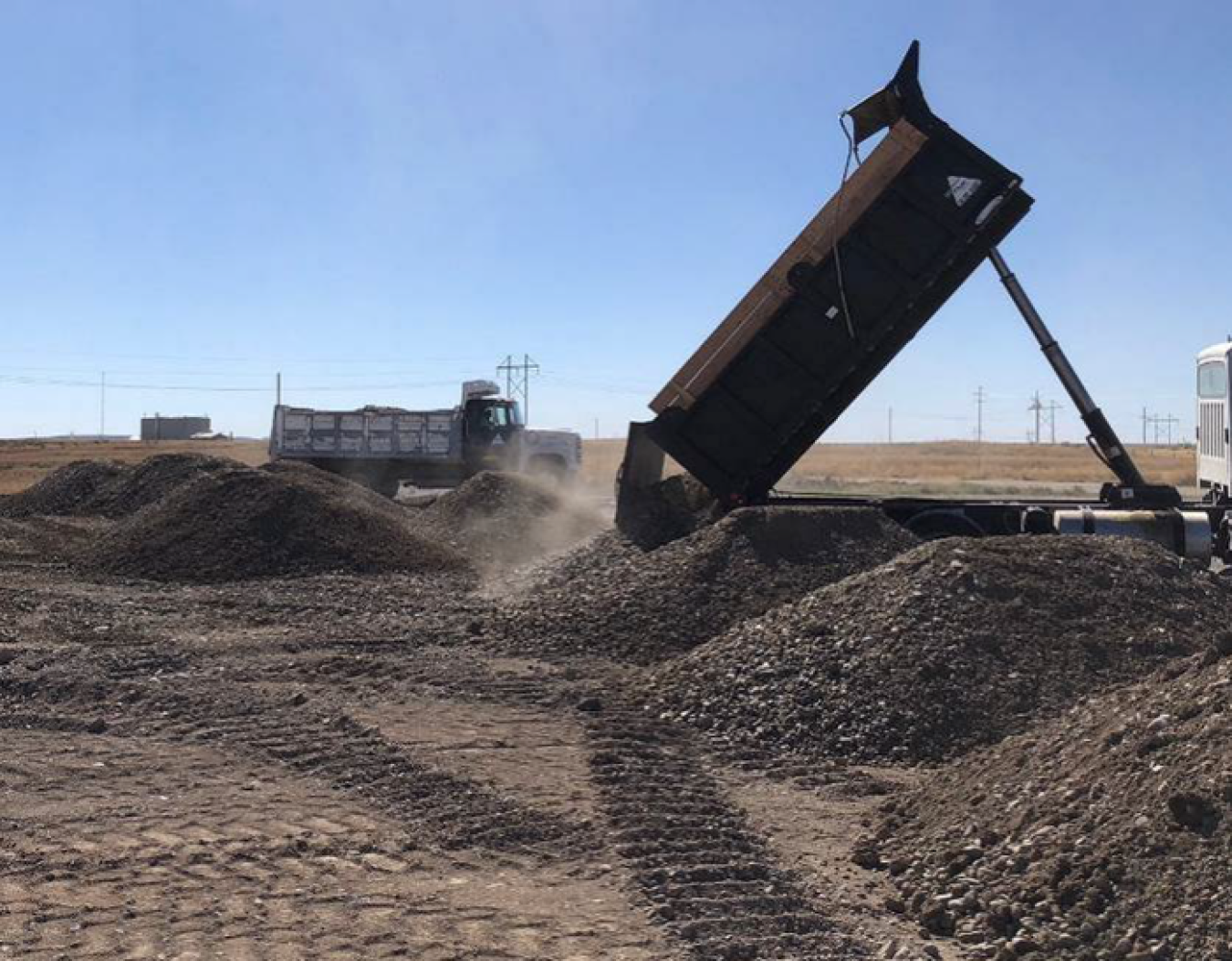 Heavy equipment was used to stockpile fill material for the landfill cover. The material was trucked from a borrow source near the Advanced Test Reactor Complex.