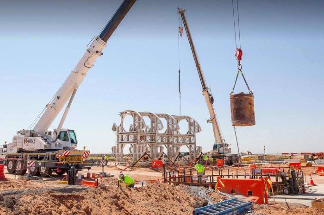 A bucket of excavated dirt is lifted out of the utility shaft at the Waste Isolation Pilot Plant site.