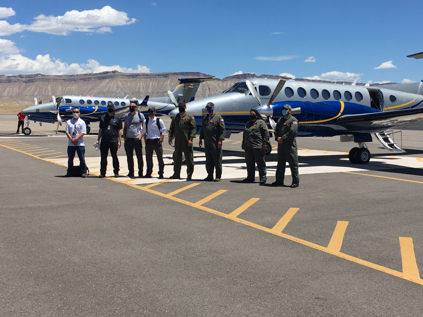 NNSA staff pose beside aircraft outfitted with radiation sensor systems at the Grand Junction, Colorado, airport.