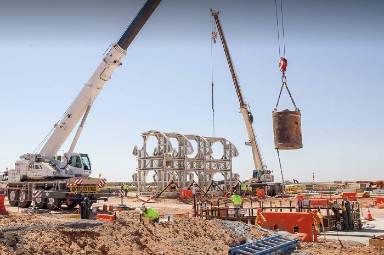 A bucket of excavated dirt is lifted out of the utility shaft that is being excavated at the Waste Isolation Pilot Plant.