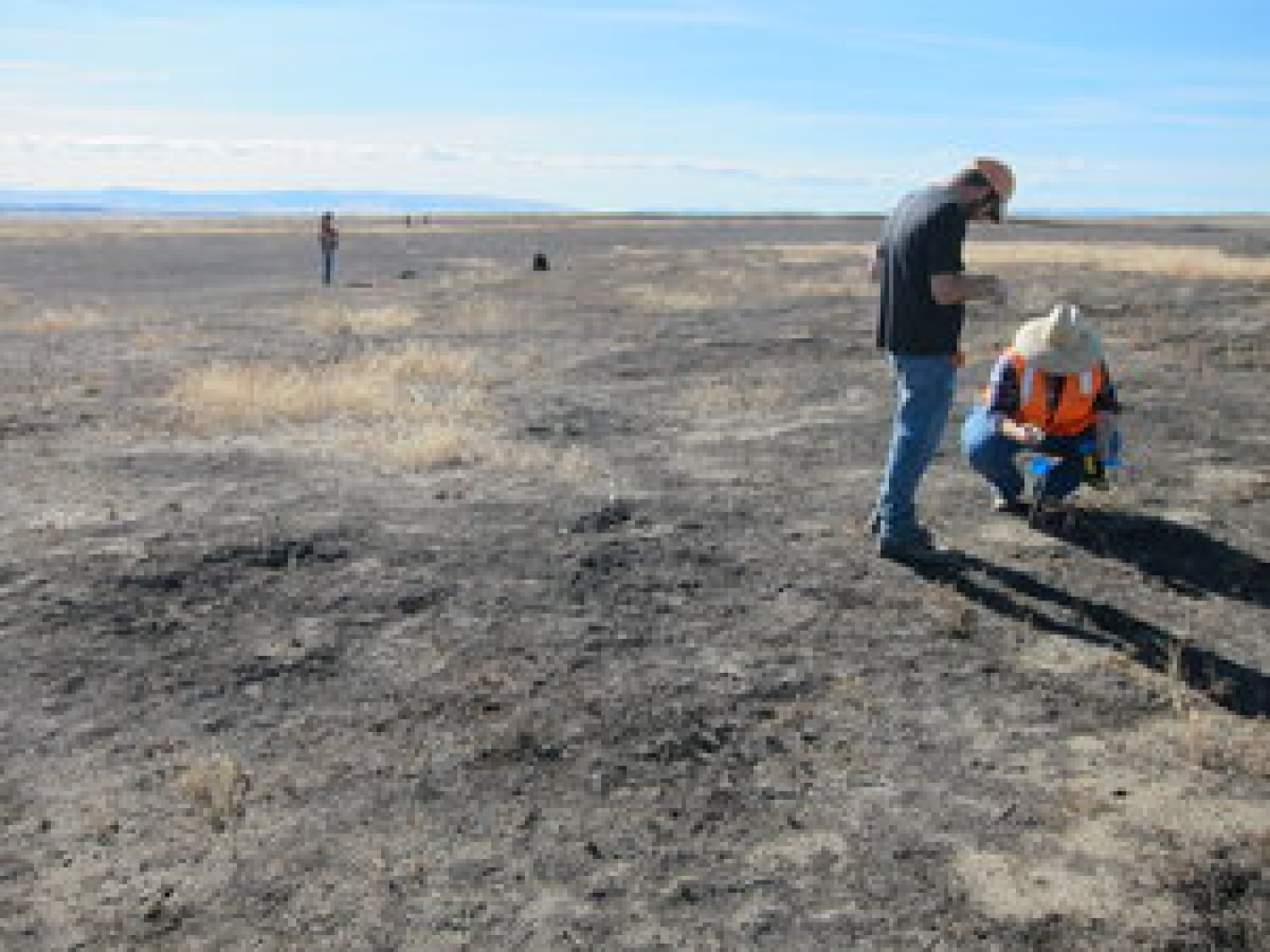 Archaeologists Keith Mendez, at left, and Mary Petrich-Guy with EM Richland Operations Office contractor Mission Support Alliance’s cultural and historic resources program document an archaeological site on the Hanford Reach national monument, with an add