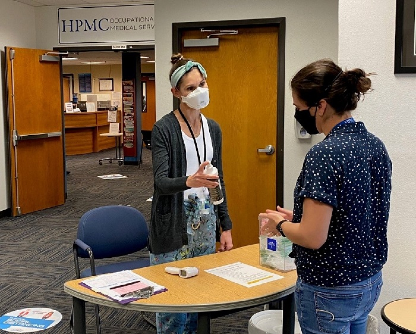 Audrey Wright, health educator for the Hanford medical services provider, conducts a brief health screening for a worker entering one of the site’s occupational medical facilities.