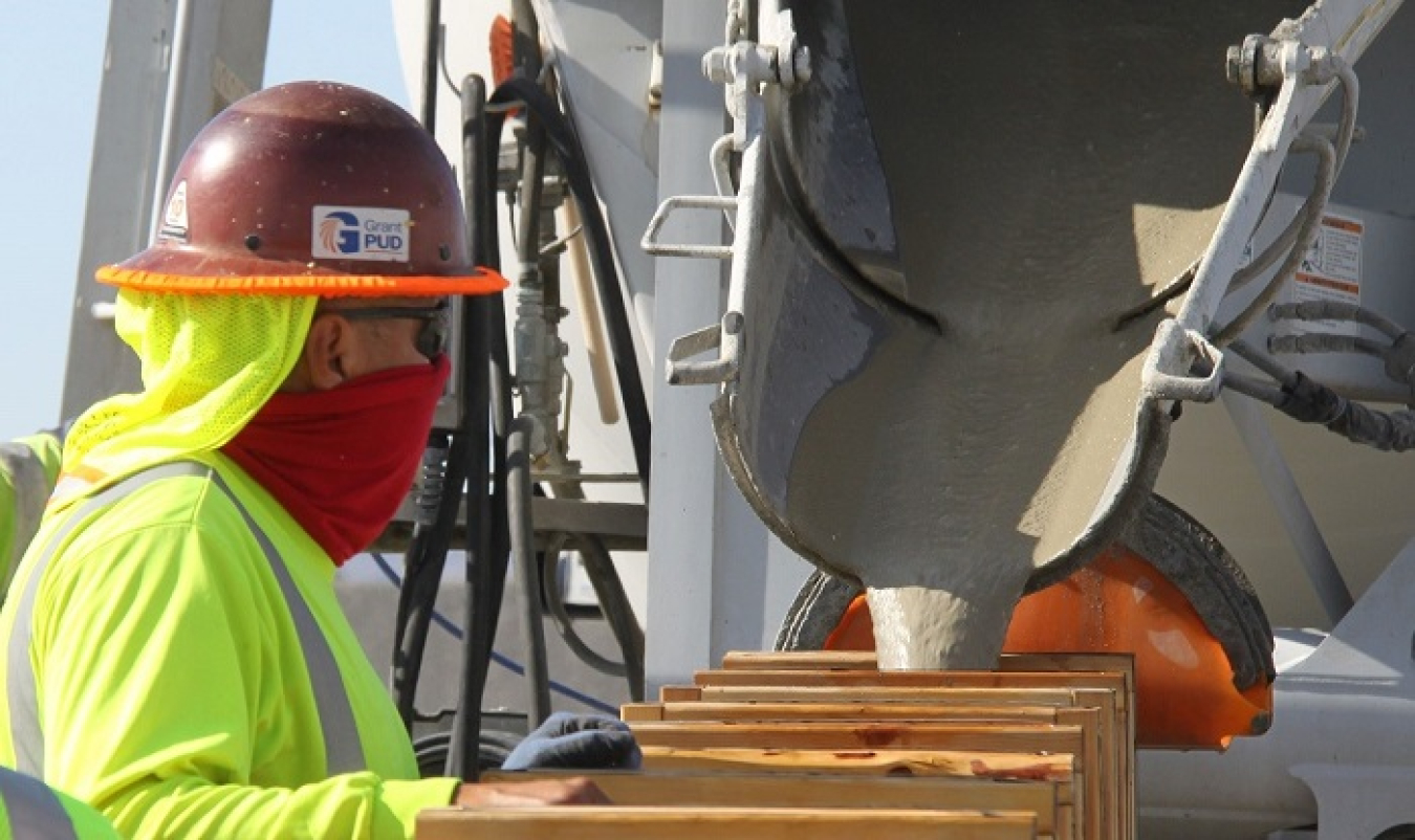 Eddie Fernandez, field superintendent, monitors the flow of a test batch of engineered grout before it is used to stabilize aging underground structures in the 200 West Area of the Hanford Site.