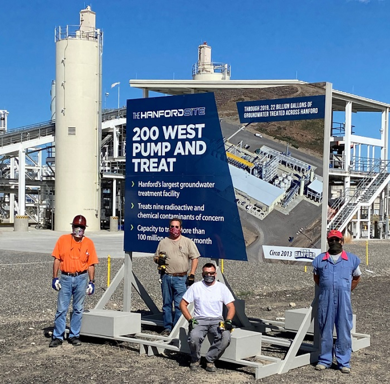 From left, Hanford Site carpenters Carl McLaughlin, Rick Russert, Mike Finney, and Doug MacDonald pause for a photo after installing one of 15 landmark signs.