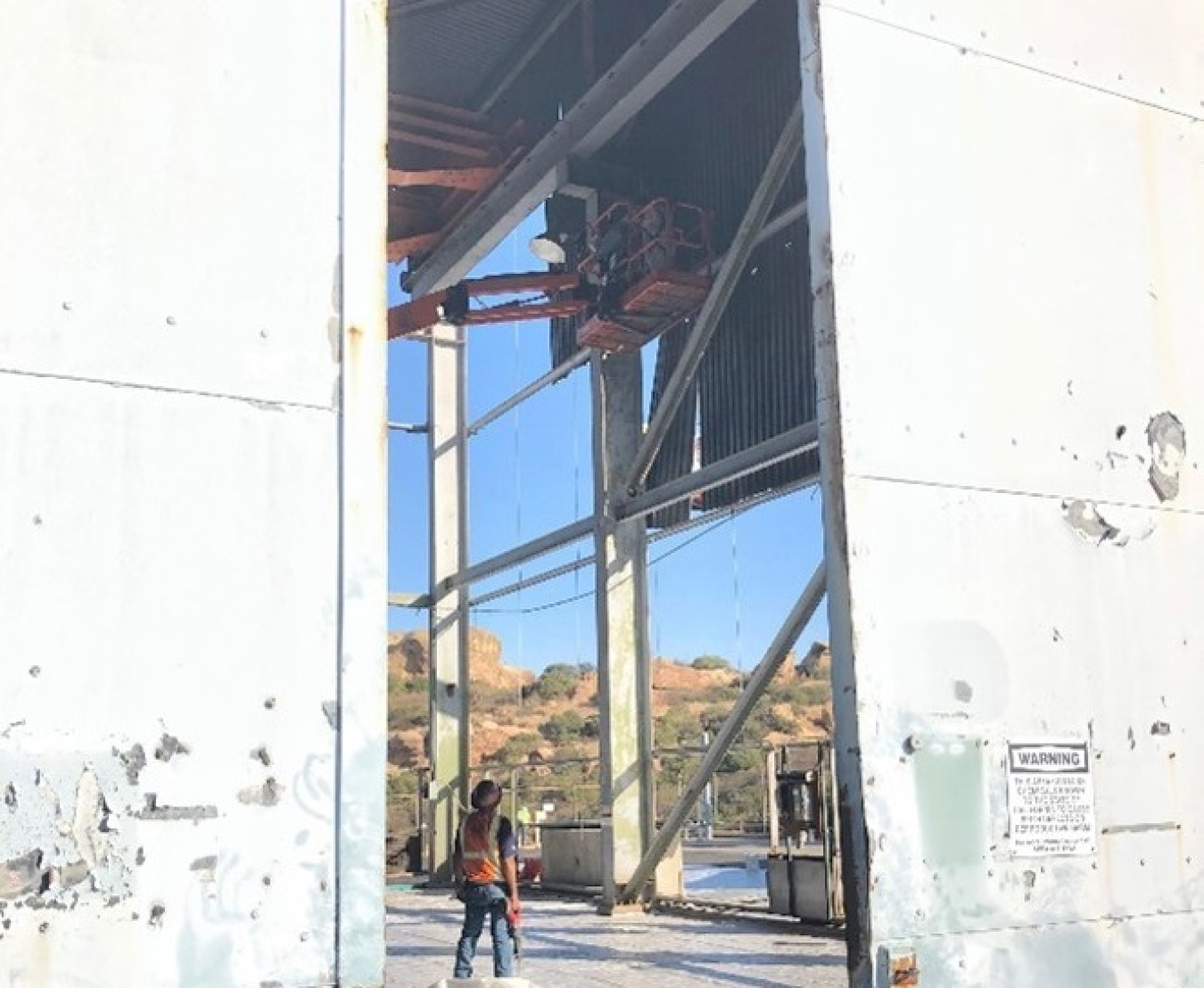 Crews remove asbestos siding at Building 4022 at the Energy Technology Engineering Center’s Radioactive Materials Handling Facility.