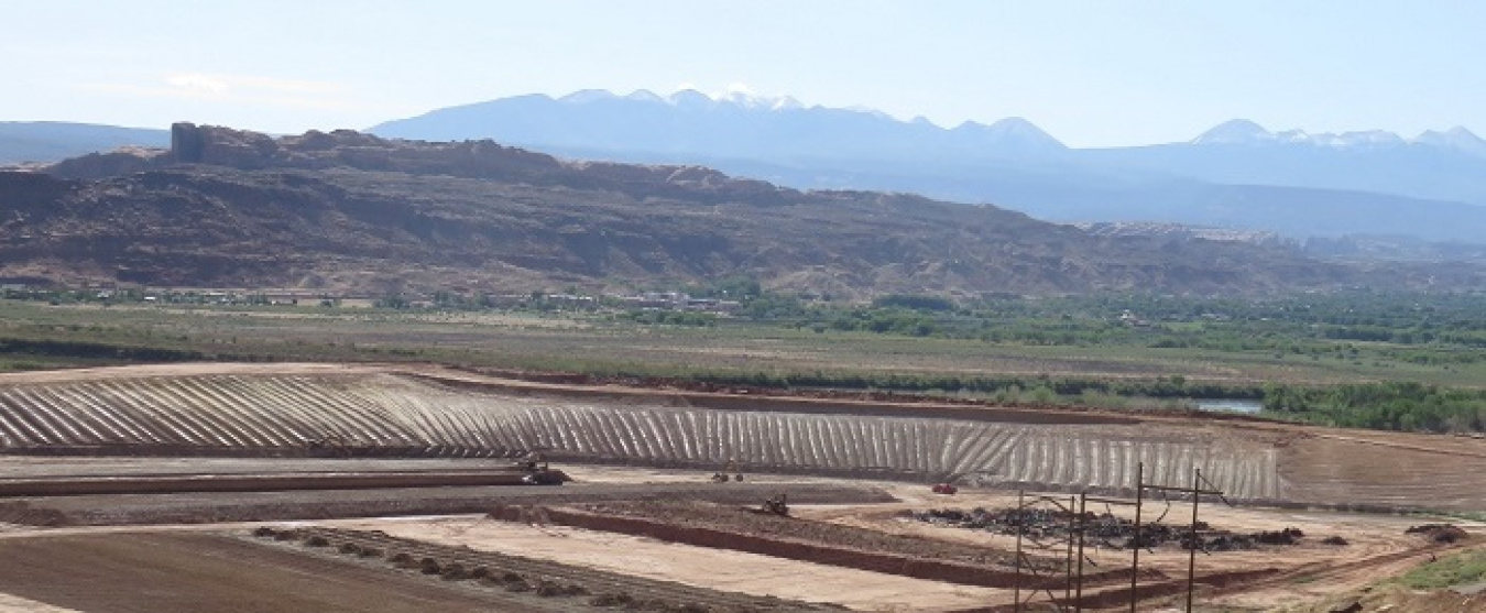 At the center of this photo is what remains of the tailings pile at the Moab Uranium Mill Tailings Remedial Action Project’s Moab, Utah site. Debris from the former mill is seen on the lower right.