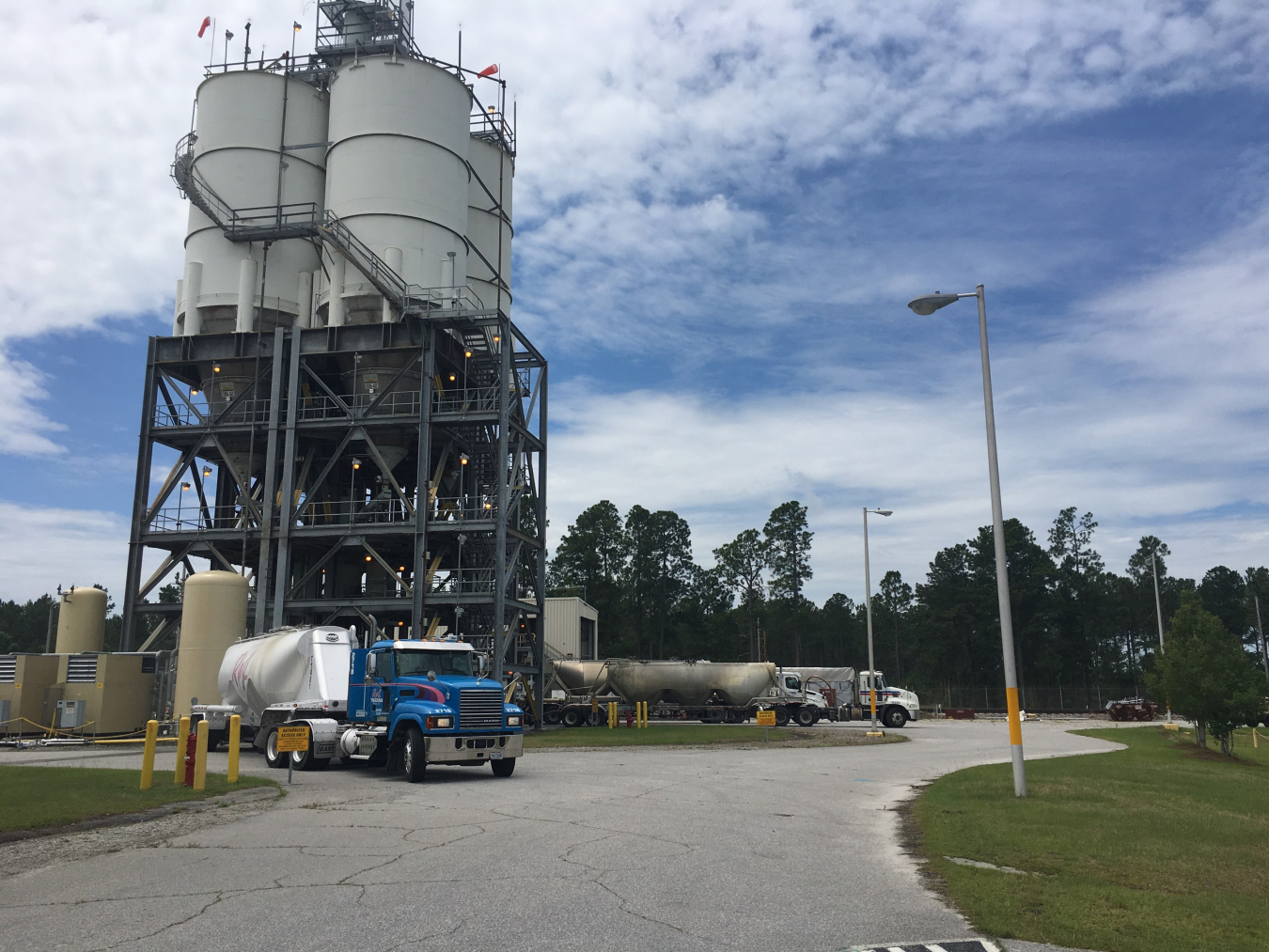 Three trucks simultaneously unloading cold feed materials at the Saltstone Production Facility