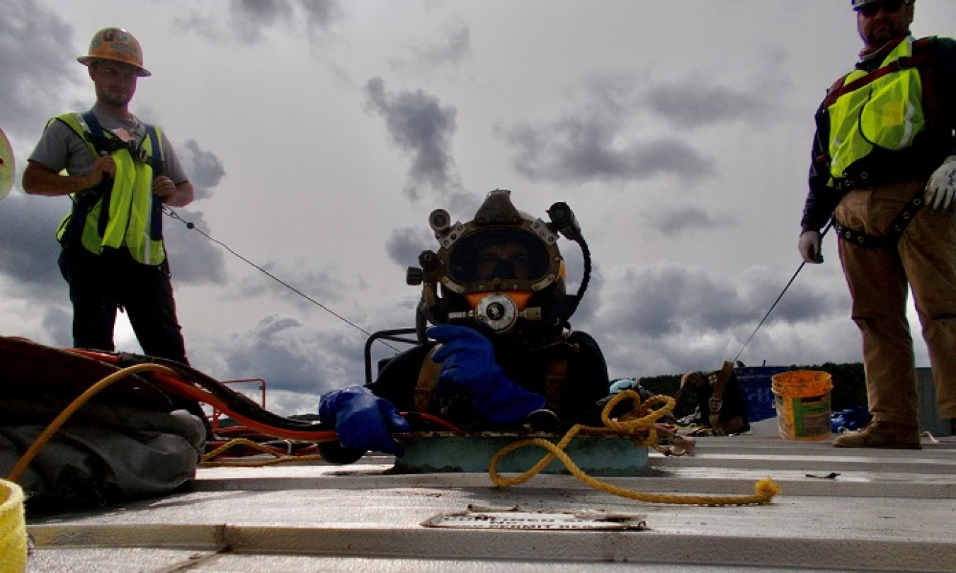 Divers Perform Underwater Maintenance of Fire Water Storage Tank at West Valley