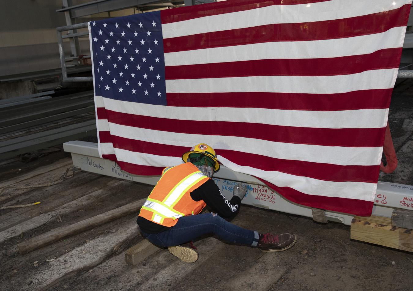 A UPF employee signs the last piece of structural steel at Y-12’s Oct. 26 “topping out” ceremony.