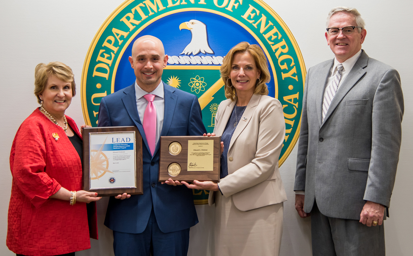 Ed Ordonez receives a plaque from NNSA Administrator Lisa E. Gordon-Hagerty for successfully completing NNSA’s Mid-Level Leadership Development Program.