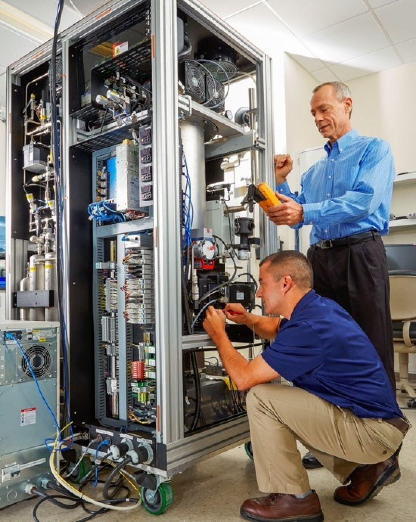 Rey Suarez, left, and Jim Hayes of Pacific Northwest National Laboratory work on the Xenon International prototype.