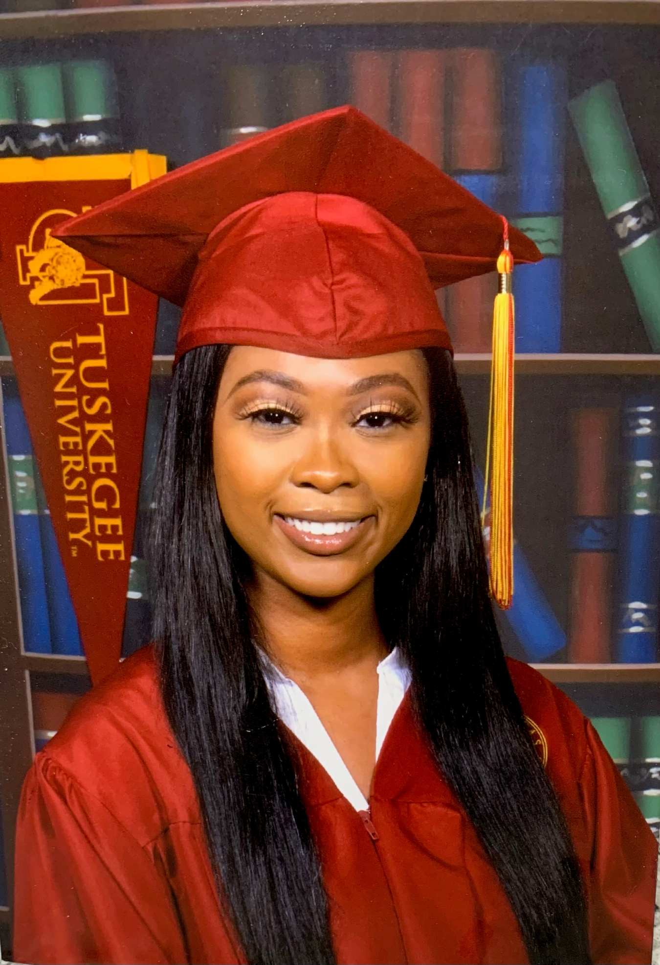 Head shot of a women in a graduation cap and gown.
