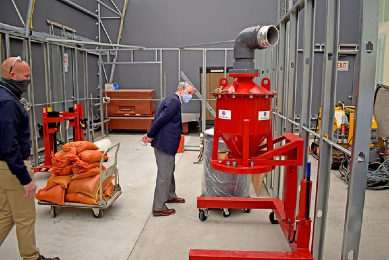 EM Senior Advisor William “Ike” White, right, ended his visit to the Hanford Site last week with a stop at a mock-up of a former plutonium processing laboratory located near Richland, Washington, and the Columbia River.