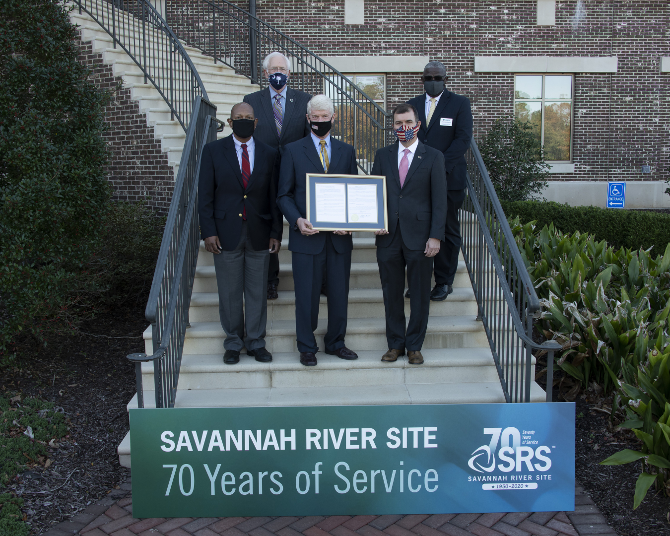 Elected officials gathered with Site leaders on the steps of the Aiken Municipal Building on Nov. 16 to bestow the framed resolution to the SRS.