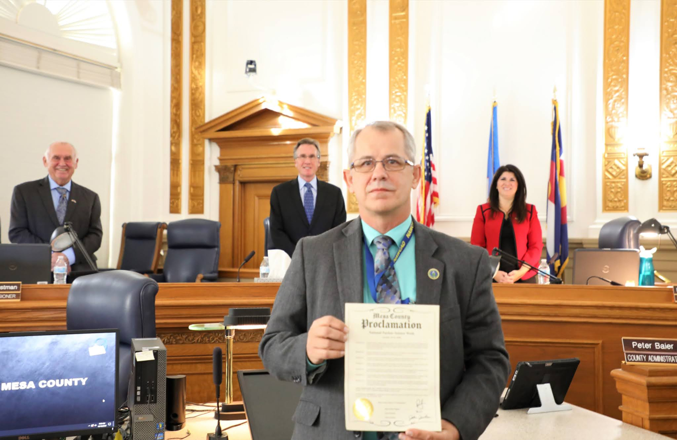 LM Public Participation Specialist Greg Kuntz receives the official proclamation of Nuclear Science Week in Mesa County, presented on behalf of the Mesa County Board of County Commissioners. 