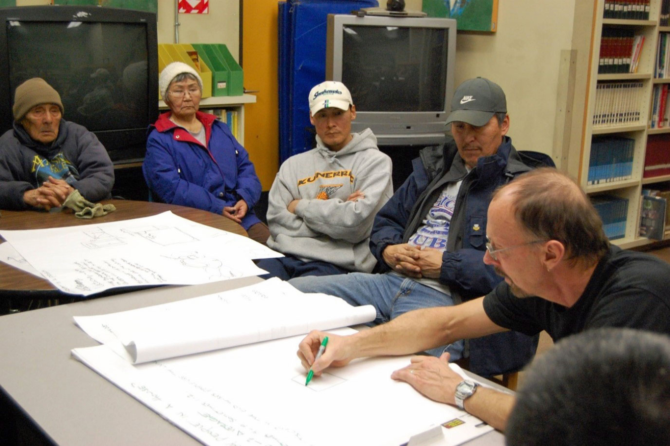 Man planning a demonstration with a community.