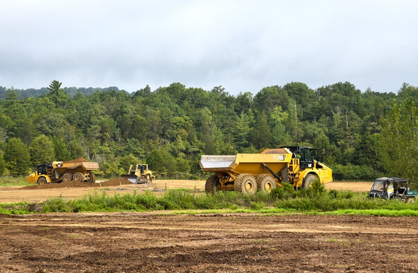 Crews place soil cover at a former oil tank farm site that once supported the K-770 Powerhouse.