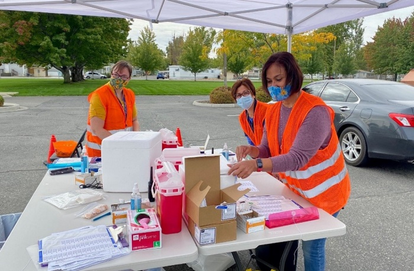Nurses prepare flu vaccines and rosters at a Hanford Site drive-up flu clinic.