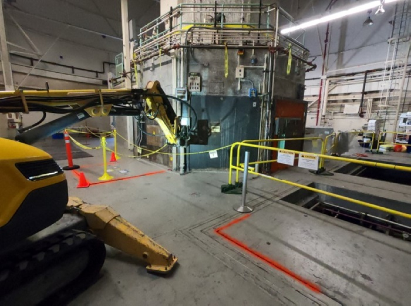 Workers conduct a simulated demolition as part of a study to determine potential impacts from the Livermore Pool Type Reactor demolition scheduled to begin in spring next year. 