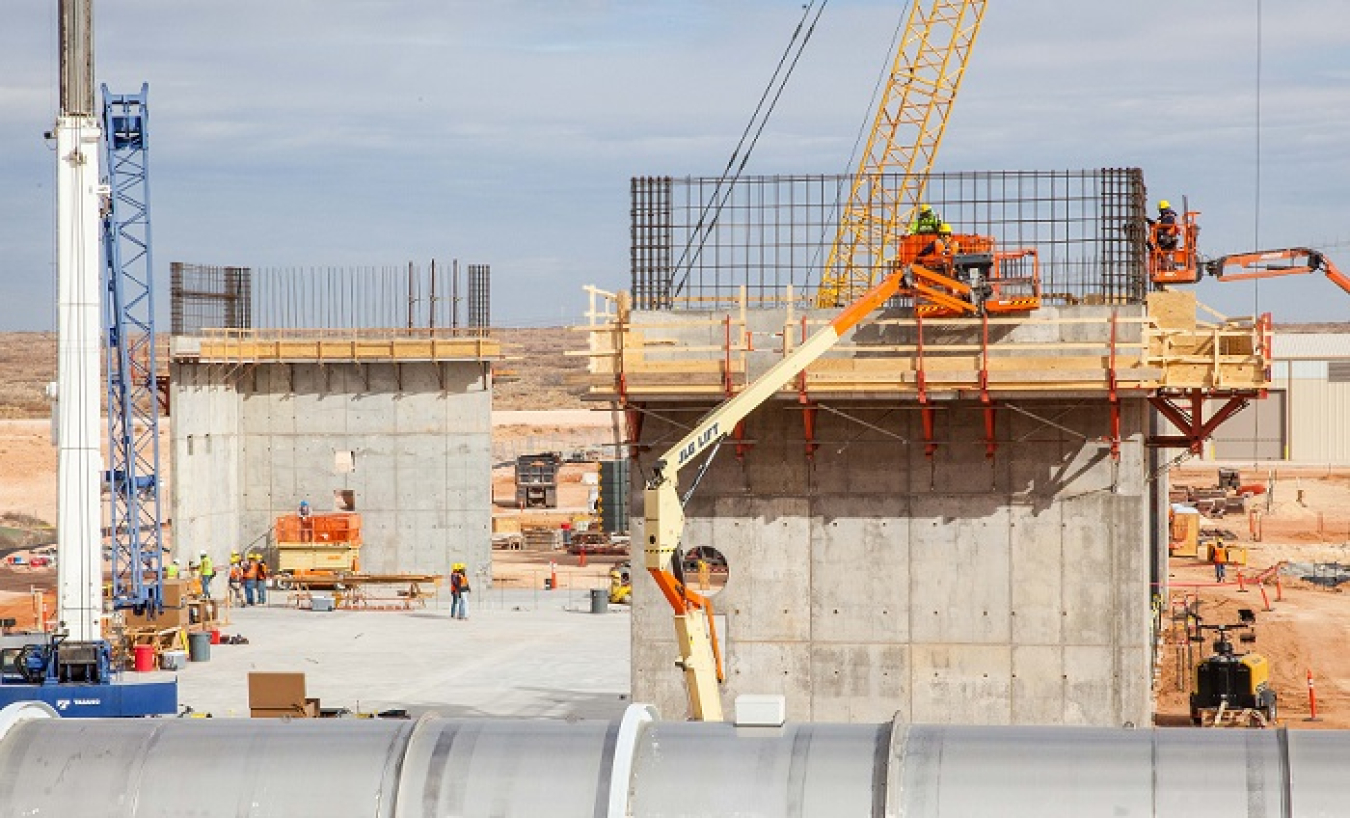 Workers prepare rebar for another concrete pour atop the shear walls of the Salt Reduction Building, which is part of the Waste Isolation Pilot Plant (WIPP) Safety Significant Confinement Ventilation System. The building will use misters and filters to extract salt from the airflow before the air heads to the high-efficiency particulate air (HEPA) filtration of the New Filter Building, which uses 1,000-horsepower fans to pull air through the mine and to the surface.