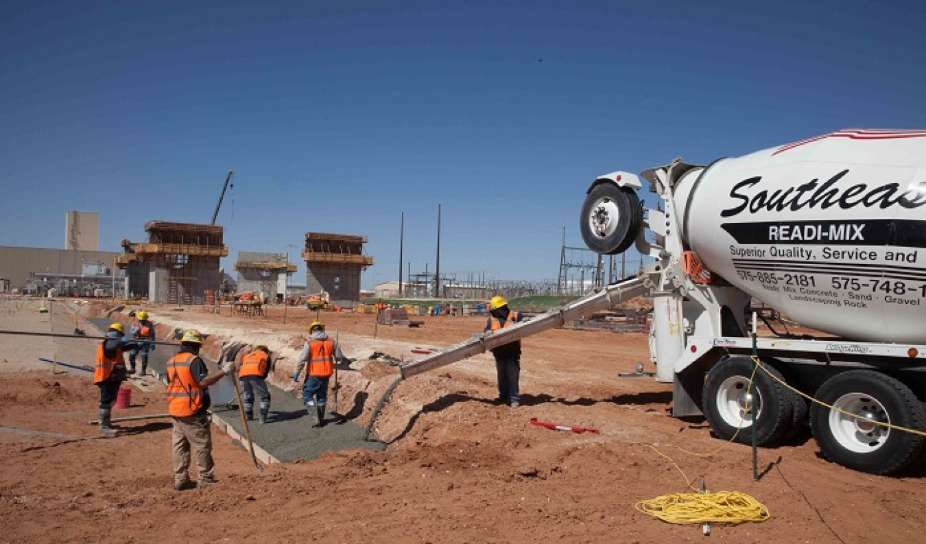 Workers pour concrete for what is known as a mud mat at the Safety Significant Confinement Ventilation System’s New Filter Building. The concrete mat will be used to place the building slab on grade formwork. The 55,000-square-foot building's filters will be the final stop for air exhausted from the Waste Isolation Pilot Plant underground repository.