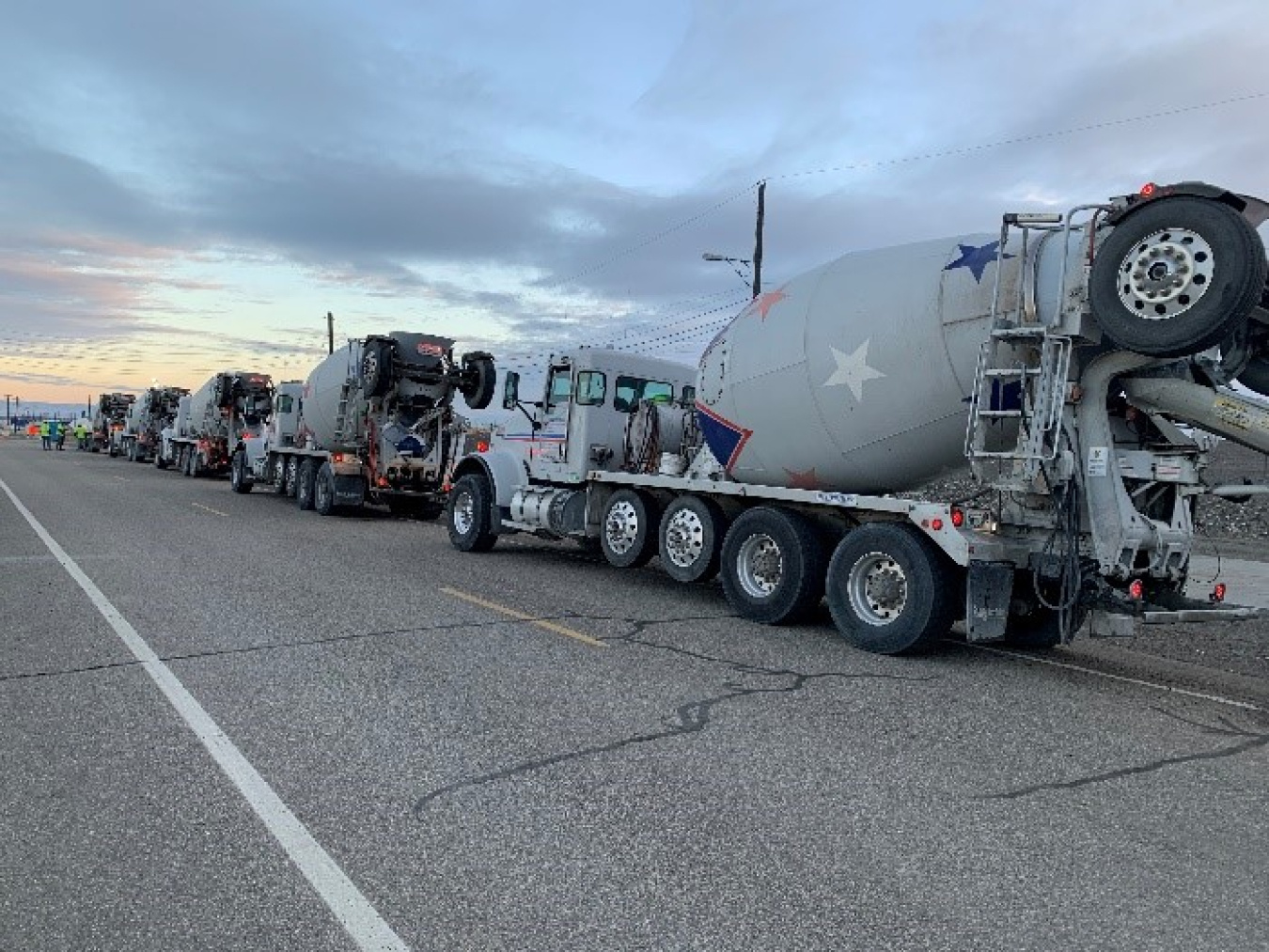 An assembly line of trucks delivers engineered grout to fill underground disposal structures, reducing risk on the Hanford Site’s Central Plateau.