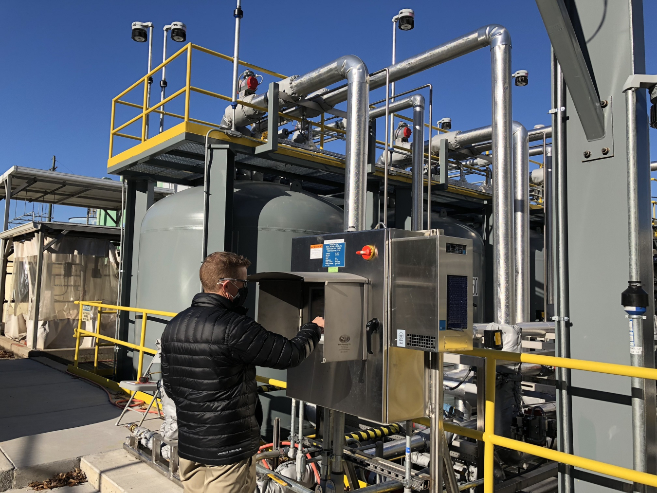 An employee configures a control panel that is part of a modernized zeolite treatment system at the Oak Ridge National Laboratory.